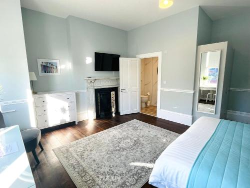 a bedroom with a bed and a fireplace at Coral House in Gorleston-on-Sea