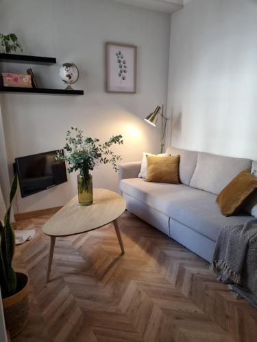 a living room with a couch and a table at Cozy apartment in the city center in Granada