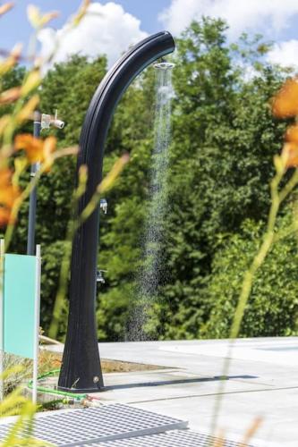 a black water fountain in a park at Luxury Villa Četiri Hrasta in Pićan