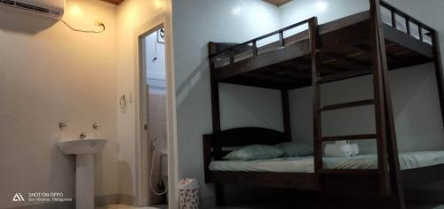 a bedroom with two bunk beds in a room at Dhong and Eden Home in San Vicente
