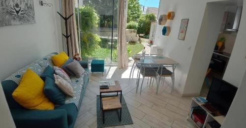 ein Wohnzimmer mit einem blauen Sofa und einem Tisch in der Unterkunft Gîte OZOO in Saint-Aignan