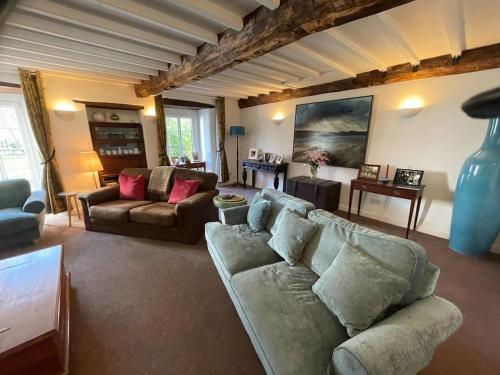 a living room with two couches and a couch at Entire country farmhouse in Cardiff