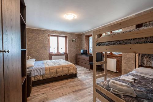 a bedroom with two bunk beds and a desk at San Luigi - Rooms & Apartments in Campodolcino