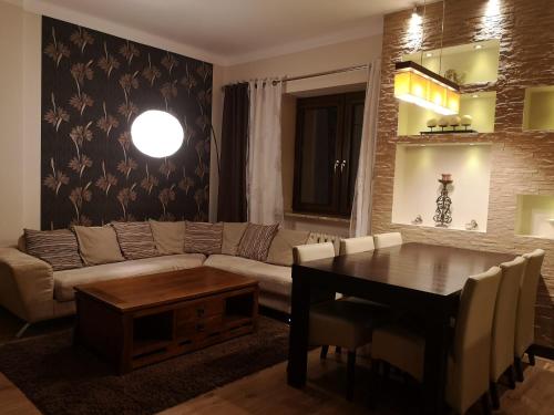 a living room with a couch and a table at Komfort in Toruń