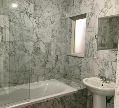 a bathroom with a bath tub and a sink at Waterkloof Mansion Boutique Hotel in Pretoria