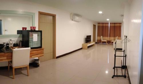 a large room with a waiting room with chairs at PUNTA CLARK HOTEL in Clark