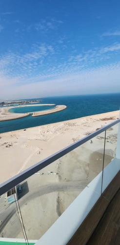 an aerial view of the beach and the ocean at studio apartment with balcony in Seef