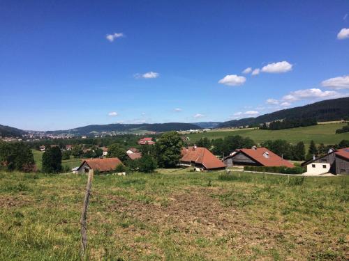 a view of a village with houses in a field at L'arbre à chapeaux in La GrandʼCombe-Châteleu