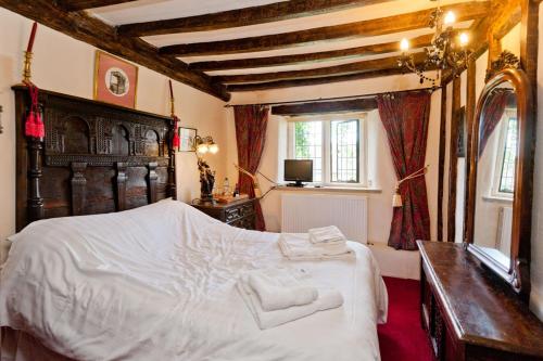 a bedroom with a large white bed and a window at Hagg Hill Hall in Wingerworth