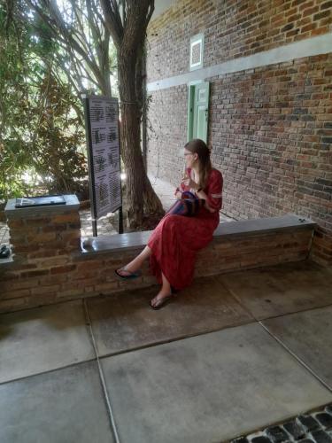 a woman sitting on a bench holding a baby at Ceylon Kingsmen Garden - Katunayake Airport Transit Hotels in Negombo