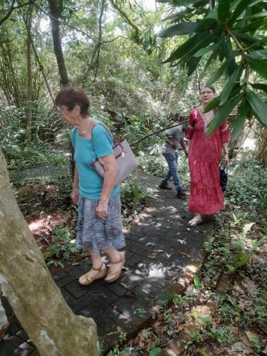 two women standing on a path in the woods at Ceylon Kingsmen Garden - Katunayake Airport Transit Hotels in Negombo