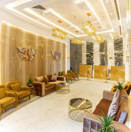 a lobby with couches and chairs and a table at Emaar Legend in Makkah