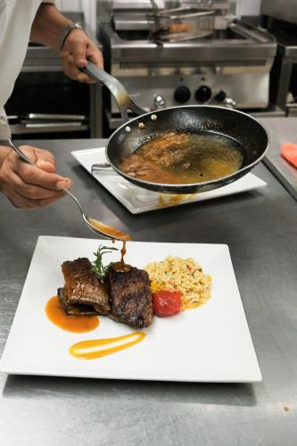 a plate of food with meat and vegetables on a table at Flamm in Golturkbuku