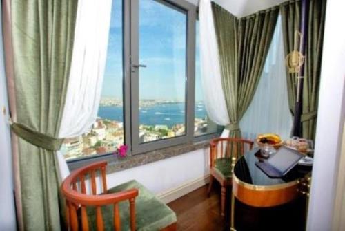 a room with a window and a chair at Taksim Star Hotel in Istanbul