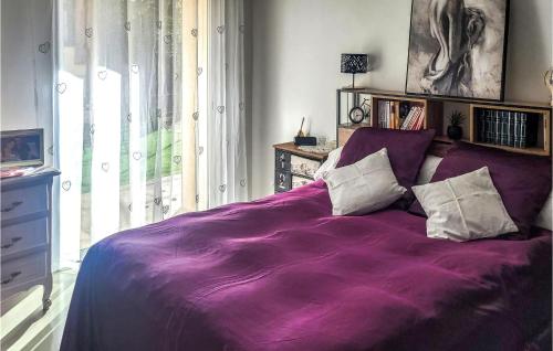a purple bed with two pillows in a bedroom at 1 Bedroom Cozy Home In Roquevaire in Roquevaire