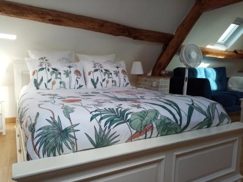 a bedroom with a large bed with plants on it at Le Grenier D'Isafil in Bordeaux-Saint-Clair