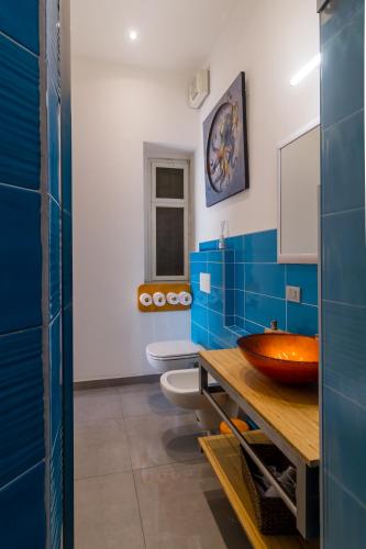 a bathroom with two toilets and a wooden sink at Casa Mazzini in Verona