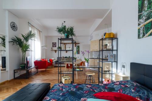 a living room with a black couch and a living room with a room at Casa Mazzini in Verona