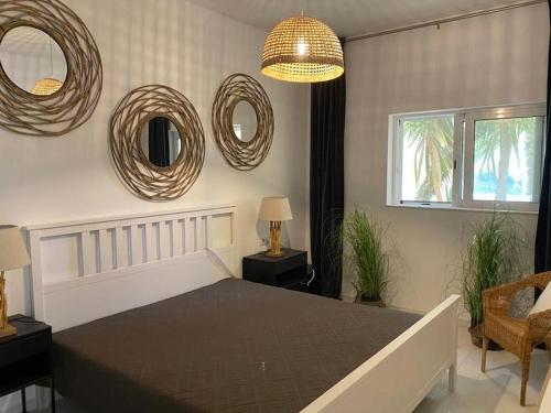 una camera da letto con un letto e specchi sul muro di The Palm Apartment Karpathos a Karpathos