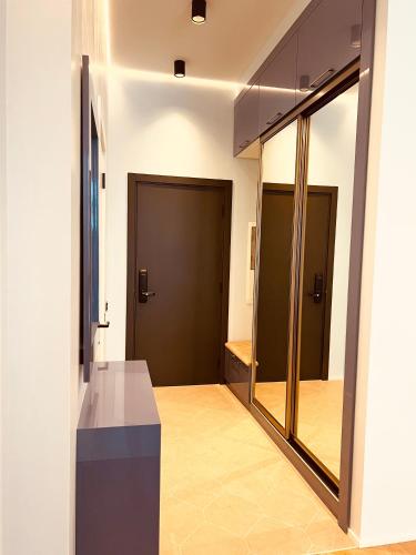 a hallway with two doors and a mirror at Baku, SEA BREEZE on the shores of the Caspian Sea in Bilgah
