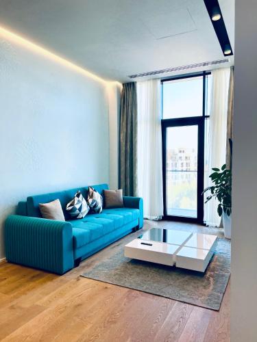 a living room with a blue couch and a coffee table at Baku, SEA BREEZE on the shores of the Caspian Sea in Bilgah