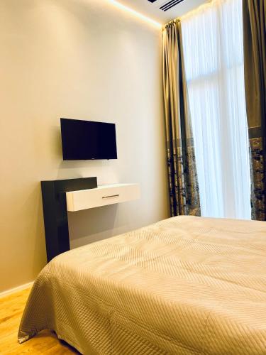 a bedroom with a bed and a flat screen tv at Baku, SEA BREEZE on the shores of the Caspian Sea in Bilgah