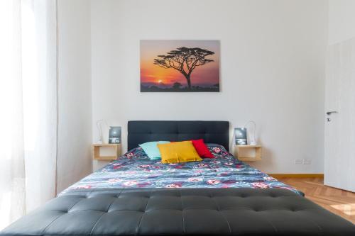 a bedroom with a bed with a painting on the wall at Casa Mazzini in Verona