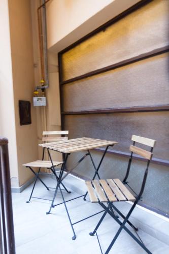 a table and two chairs in front of a wall at Casa Mazzini in Verona