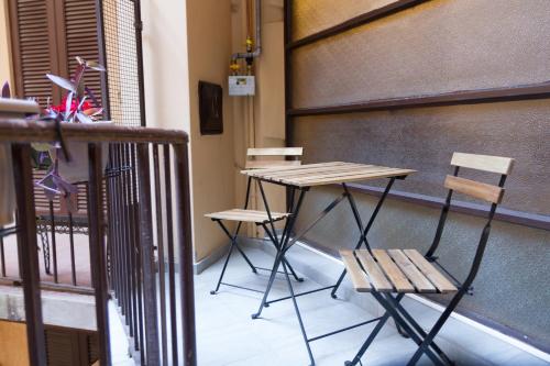 a table and two chairs on a balcony at Casa Mazzini in Verona