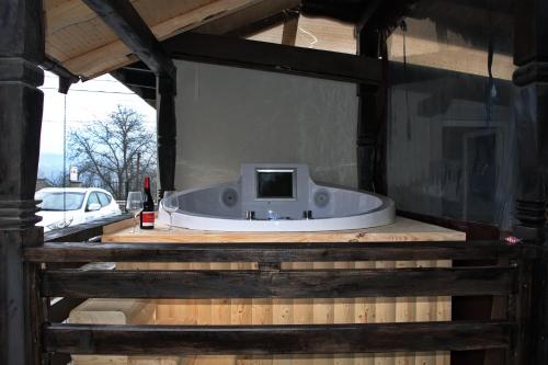 a bath tub in a building with a tv in it at La Dory in Satu Şugatag