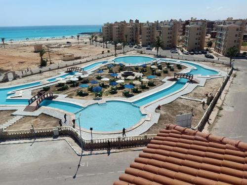 an aerial view of a swimming pool at the beach at El Obayed Apartments Armed Forces in Marsa Matruh
