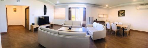 a living room with a couch and chairs and a table at PUNTA CLARK HOTEL in Clark