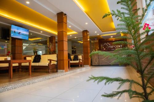 a lobby of a hotel with tables and chairs at Magnificent Hotel in Kathmandu