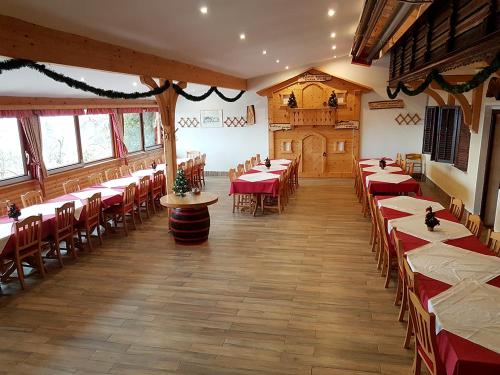 a large room with tables and chairs in a restaurant at Turizem Pavlin Apartments in Šenturska Gora