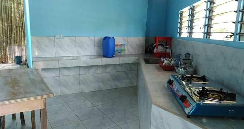 a kitchen with a stove and a counter top at CBHaus in El Nido
