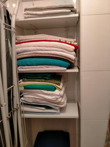 a stack of folded towels in a closet at Península de la paz in Lugo