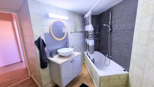 a bathroom with a tub and a sink and a bath tub at The Urban Oasis - Comfort 2br near the City Center, 200Mbit Internet and Smart TV in Larnaca