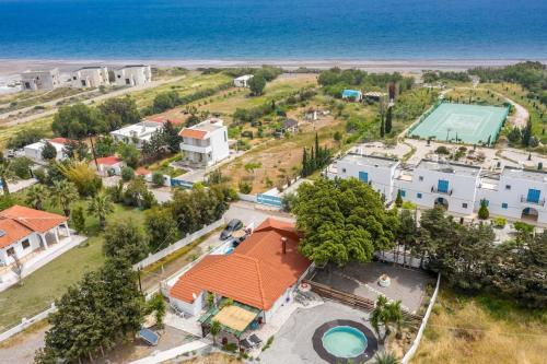 an aerial view of a house with a pool and the ocean at Cavo Prima Kiotari in Gennadi