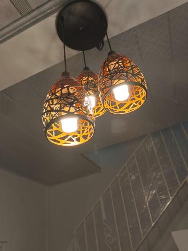 a group of lights hanging from a ceiling at D'Ariska Rooms Homestay in Jombang