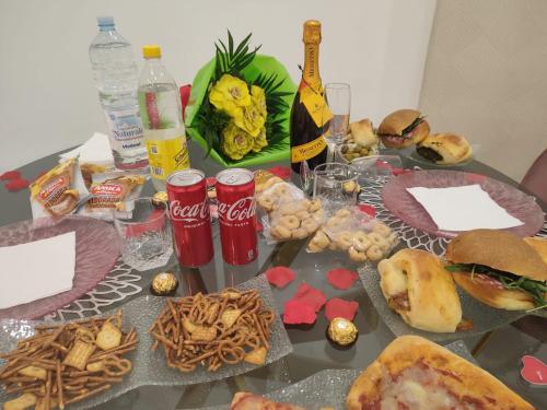 a table topped with plates of food and drinks at Maison De luxe in Pompei