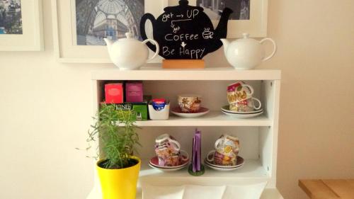 a shelf with cups and plates of food on it at B&B Floridiana in Naples