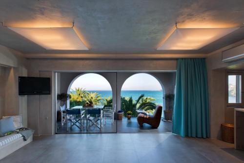 een woonkamer met uitzicht op de oceaan bij Calypso Villas in Amoudi