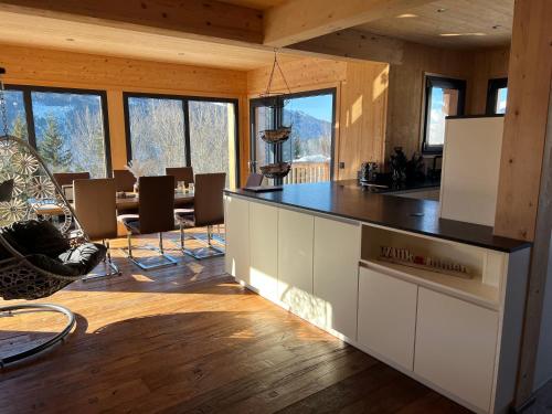 a kitchen with a counter top in a room with windows at Bergchalet Stolzalpe 