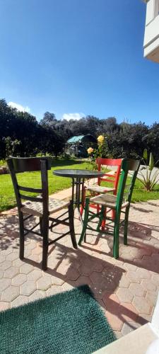 two chairs and a table and a table and bench at Salavantes House in Chania Town