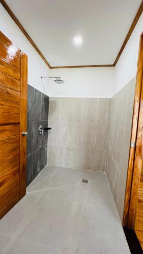 an empty room with a door and a tiled floor at Gilligans Port Barton Beach Resort in San Vicente