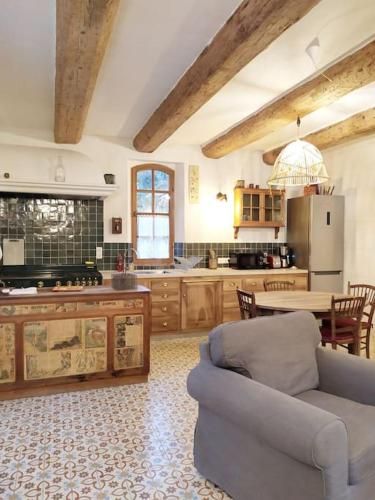 - une cuisine avec un canapé et une table dans une chambre dans l'établissement Charmante bergerie dans un cadre bucolique, à Saint-Rémy-de-Provence
