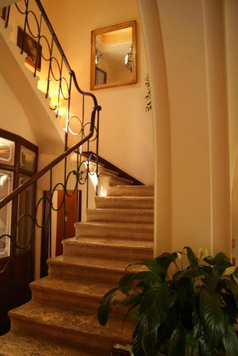 a staircase in a house with a mirror on the wall at Hotel Santa Caterina in Siena