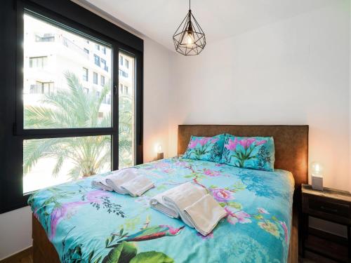 a bedroom with a bed with a large window at Belvilla by OYO Casa Joyosa in Villajoyosa
