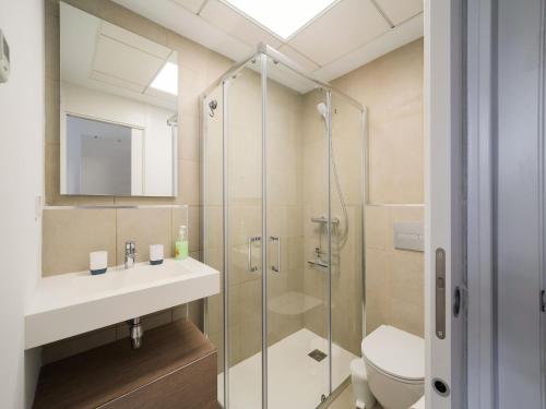 a bathroom with a shower and a sink and a toilet at Belvilla by OYO Casa Joyosa in Villajoyosa
