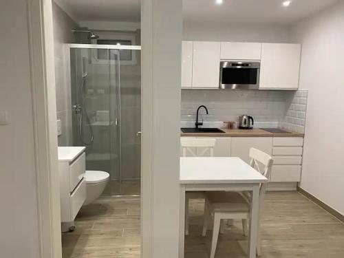 a white kitchen with a toilet and a sink at Cloe Apartment in Split
